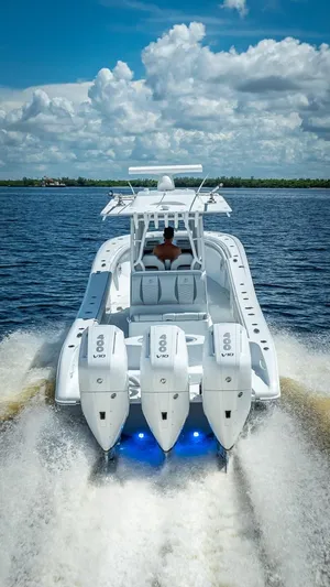  Yacht Photos Pics 2025 Yellowfin 36 boat cruising on open water under a cloudy sky.