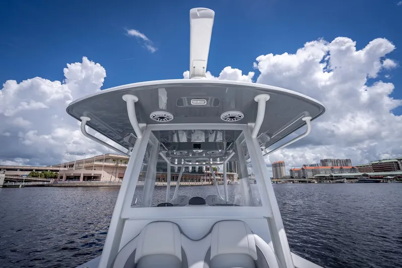  Yacht Photos Pics 2025 Yellowfin 36 boat on water, showcasing sleek design under a partly cloudy sky.