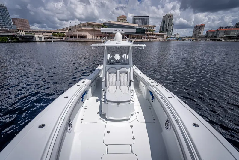  Yacht Photos Pics 2025 Yellowfin 36 boat on water with city skyline in background.
