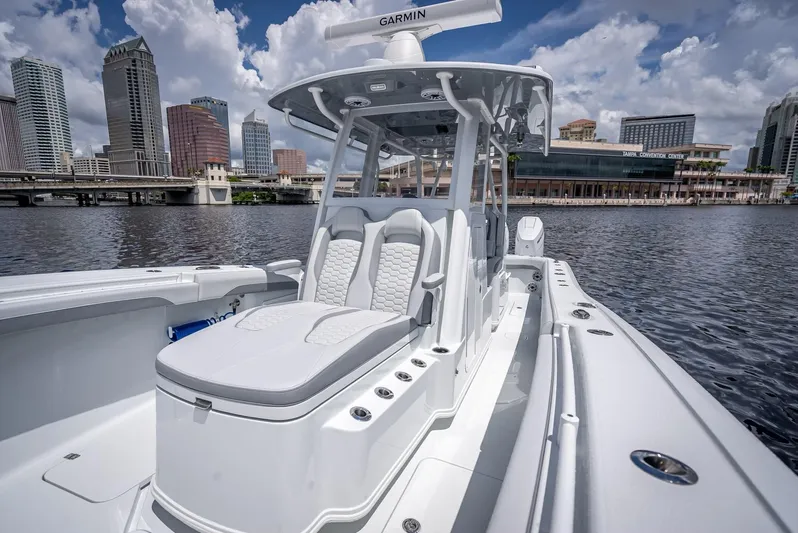  Yacht Photos Pics 2025 Yellowfin 36 boat with sleek design, docked in urban waterfront setting.