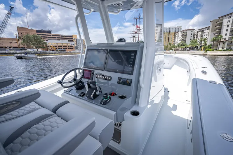 Yacht Photos Pics 2025 Yellowfin 36 boat console with modern controls, docked in urban marina.