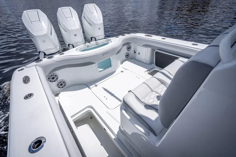  Yacht Photos Pics 2025 Yellowfin 36 boat interior with triple outboard engines, sleek seating, and modern design.
