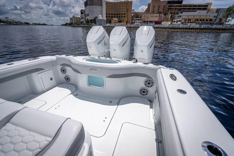  Yacht Photos Pics 2025 Yellowfin 36 boat with triple outboard engines on calm water.