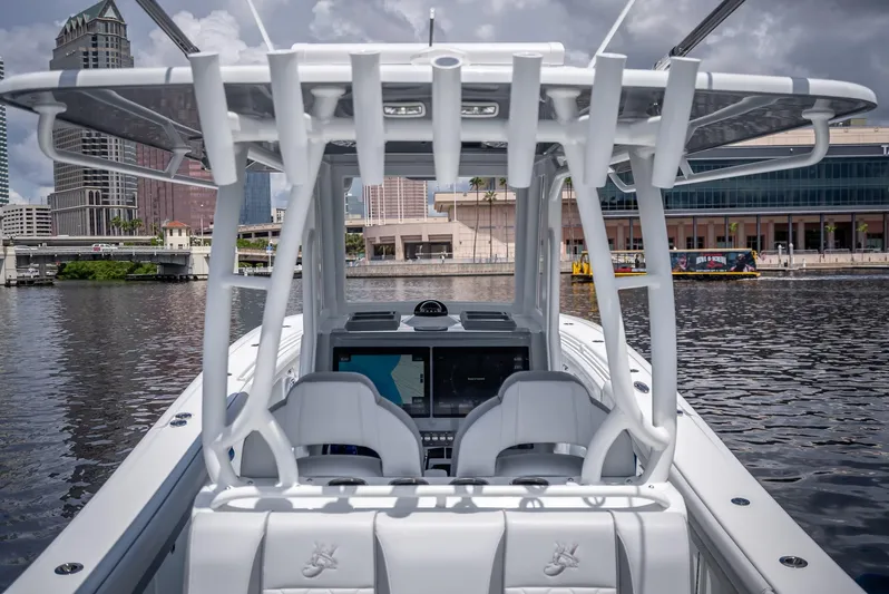  Yacht Photos Pics 2025 Yellowfin 36 boat on water, cityscape background, modern design, spacious cockpit.