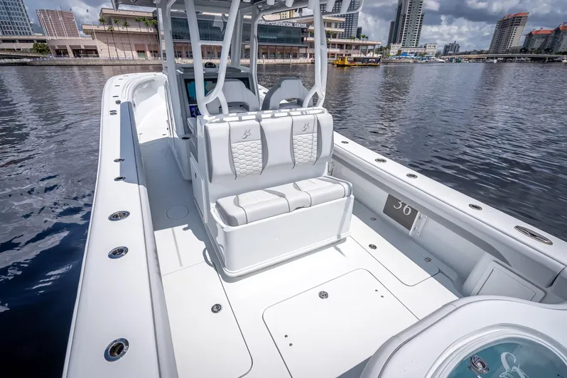  Yacht Photos Pics 2025 Yellowfin 36 boat with sleek design, docked in urban waterfront setting.