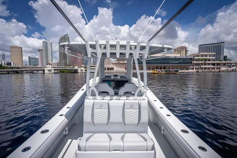  Yacht Photos Pics 2025 Yellowfin 36 boat on water with city skyline in background.