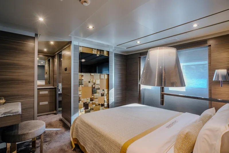 Charisma Yacht Photos Pics Luxurious bedroom interior on a 2015 Benetti Fast 125 yacht, featuring modern design and elegant lighting.