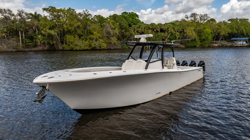 Catahoula Yacht Photos Pics 2023 Front Runner 39 Center Console boat on a serene river with lush greenery.