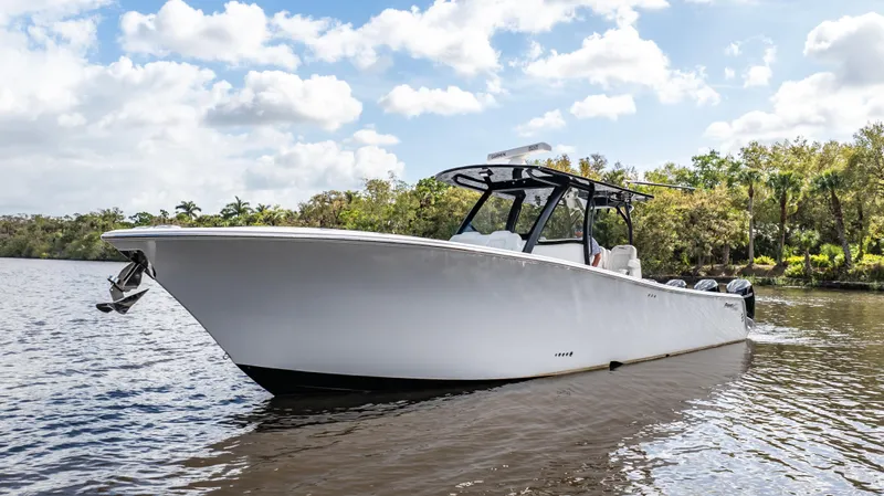 Catahoula Yacht Photos Pics 2023 Front Runner 39 Center Console boat on a calm river under a cloudy sky.