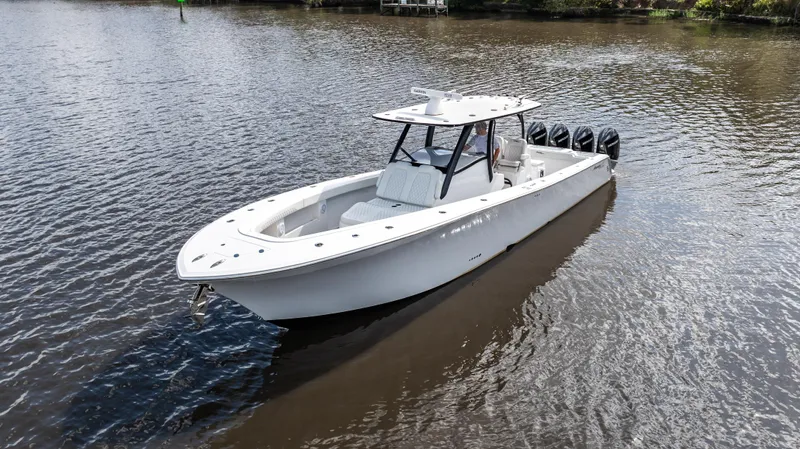 Catahoula Yacht Photos Pics 2023 Front Runner 39 Center Console boat on calm water, featuring sleek design and multiple engines.