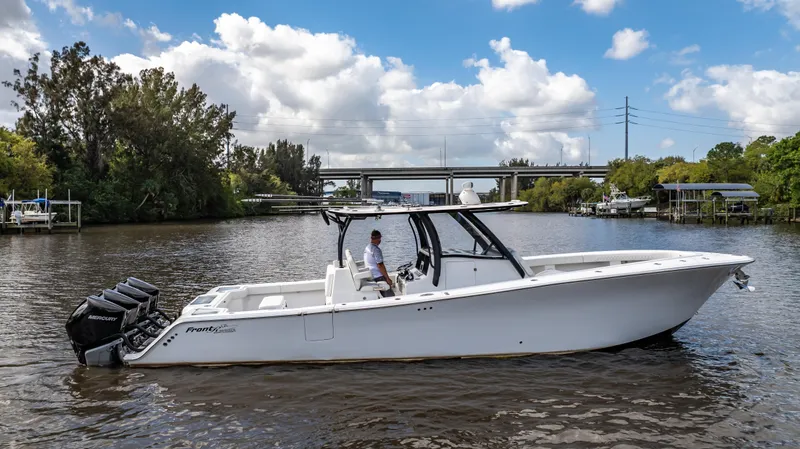 Catahoula Yacht Photos Pics 2023 Front Runner 39 Center Console boat on a calm river under a blue sky.
