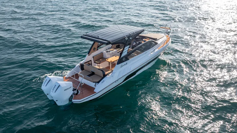  Yacht Photos Pics 2025 Hanover 305 boat cruising on open water, featuring sleek design and modern amenities.