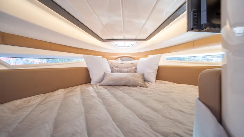  Yacht Photos Pics Luxurious interior cabin of 2025 Hanover 305 yacht with plush bedding.