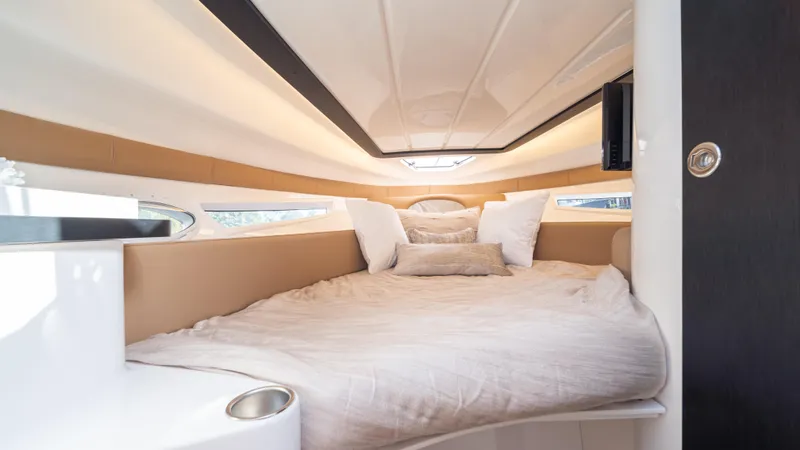  Yacht Photos Pics Luxurious cabin interior of 2025 Hanover 305 yacht with cozy bedding.