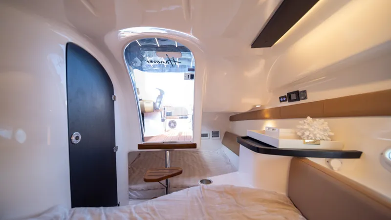  Yacht Photos Pics Modern interior of 2025 Hanover 305 boat cabin with sleek design and cozy seating.