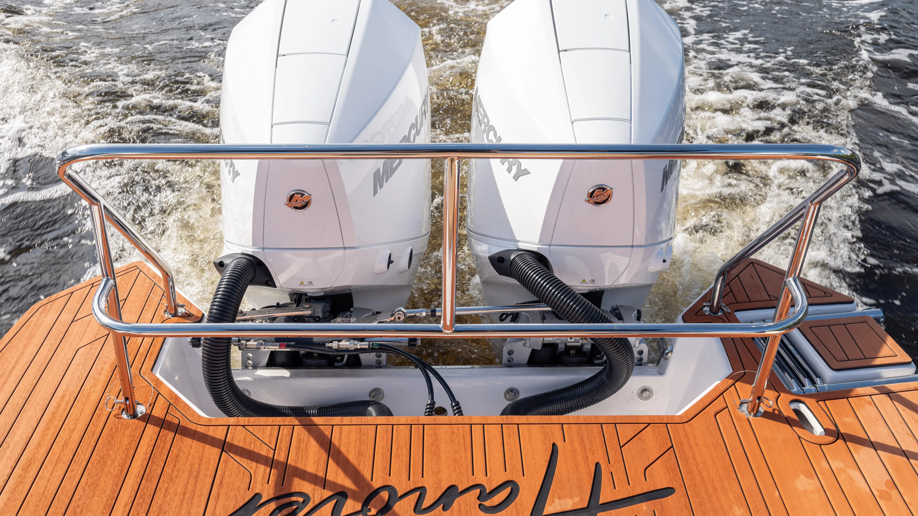  Yacht Photos Pics 2026 Hanover 305 boat with dual engines on wooden deck, cruising on water.