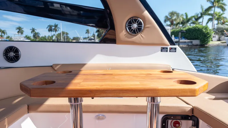  Yacht Photos Pics 2026 Hanover 305 boat interior with wooden table and scenic water view.