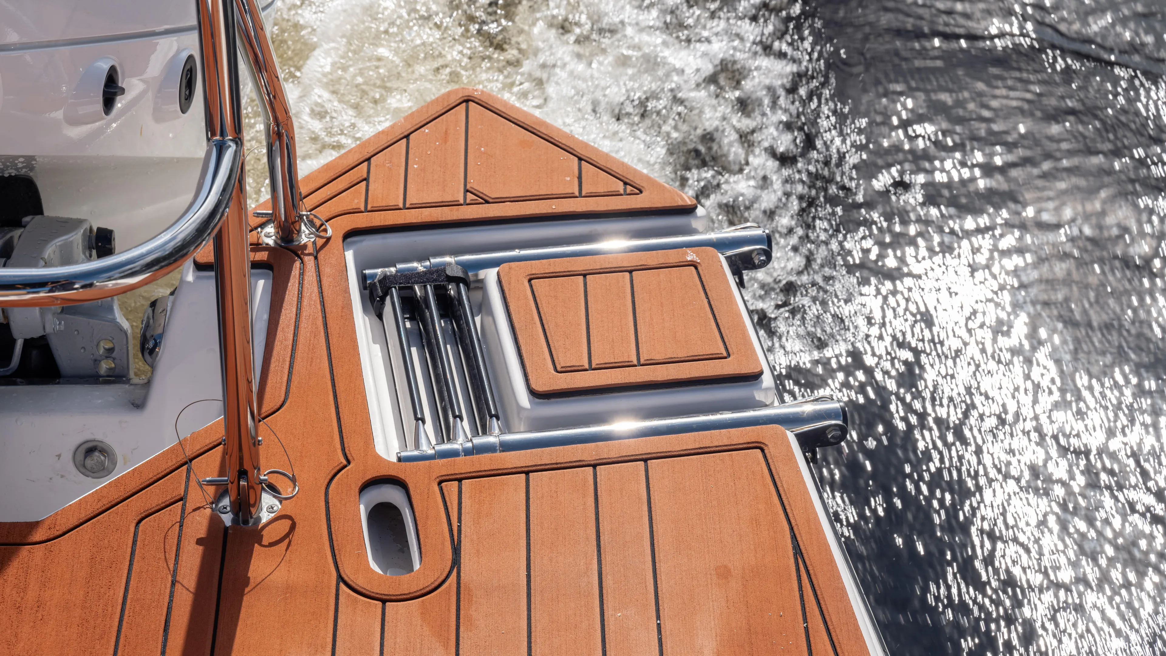  Yacht Photos Pics 2026 Hanover 305 boat deck with wooden finish and water backdrop.