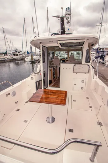 Halcyon Yacht Photos Pics Aspen C100 2015 boat interior with wooden table, docked at marina.