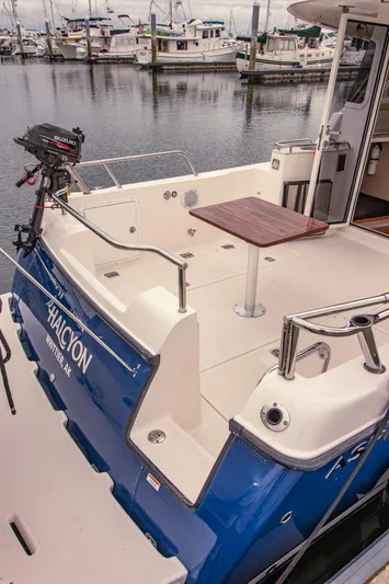 Halcyon Yacht Photos Pics Aspen C100 boat, 2015 model, docked with Suzuki outboard motor, blue and white design.