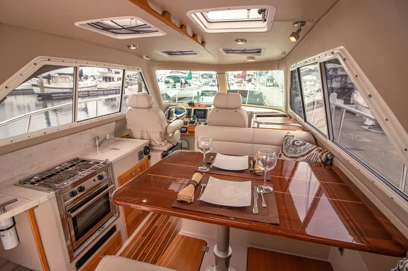 Halcyon Yacht Photos Pics Luxurious interior of 2015 Aspen C100 yacht with dining area and kitchen.