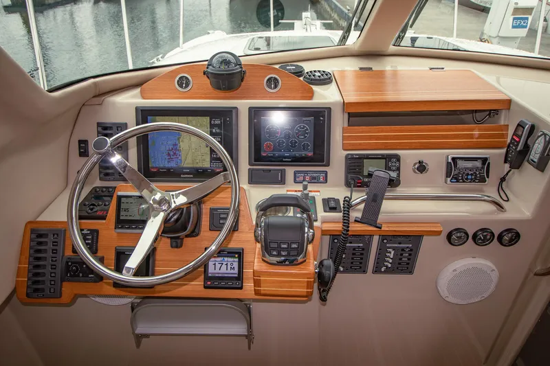 Halcyon Yacht Photos Pics Cockpit of 2015 Aspen C100 boat with steering wheel, navigation screens, and control panels.