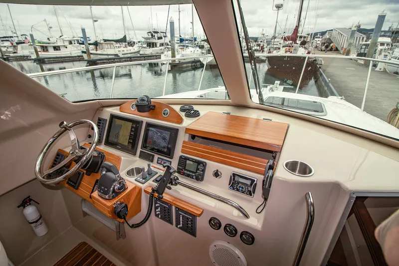Halcyon Yacht Photos Pics Cockpit of 2015 Aspen C100 boat with navigation controls and marina view.