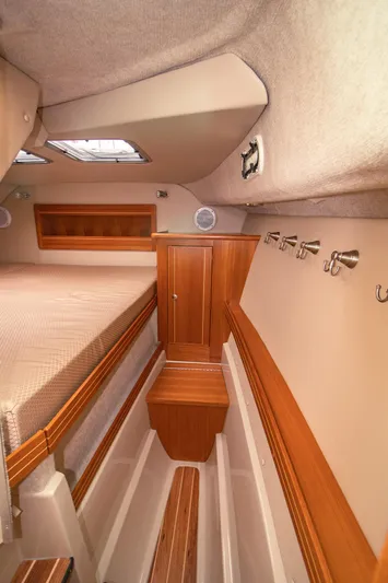 Halcyon Yacht Photos Pics Cozy cabin interior of 2015 Aspen C100 boat with wood accents and storage space.