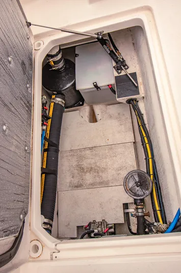 Halcyon Yacht Photos Pics Engine compartment of a 2015 Aspen C100 boat, showing hoses and mechanical components.