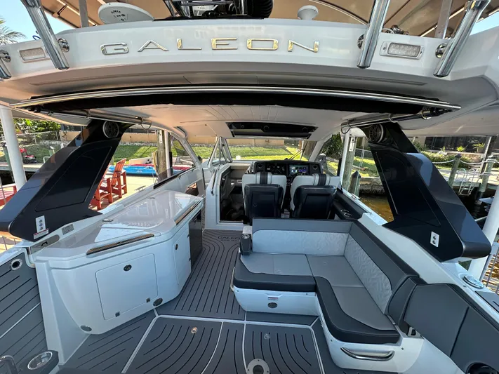  Yacht Photos Pics 2022 Galeon 325 GTO yacht interior with seating and helm, showcasing luxury design.