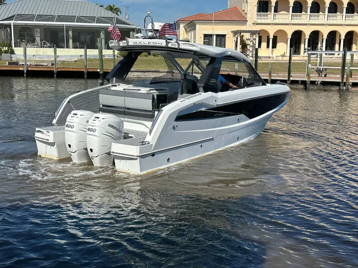  Yacht Photos Pics 2022 Galeon 325 GTO yacht with triple engines cruising near waterfront homes.