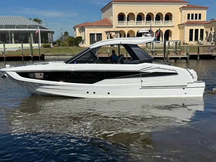 Yacht Photos Pics 2022 Galeon 325 GTO yacht cruising near waterfront homes.
