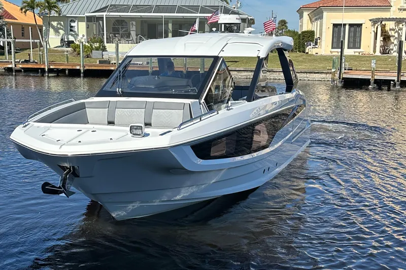  Yacht Photos Pics 2022 Galeon 325 GTO luxury yacht on calm water near docks.