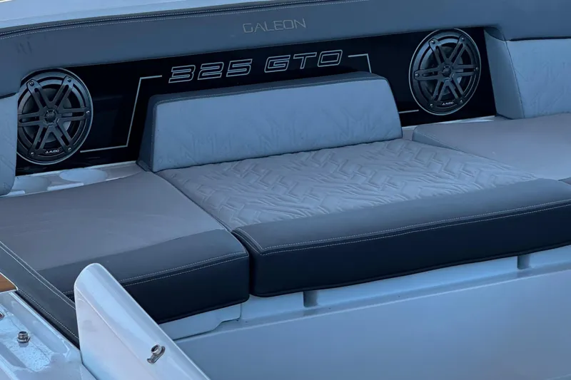  Yacht Photos Pics 2022 Galeon 325 GTO boat interior with cushioned seating and speakers.