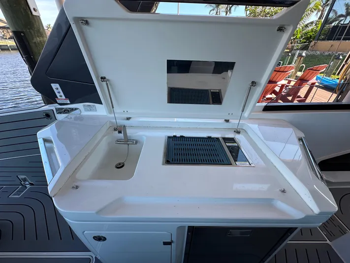  Yacht Photos Pics Outdoor kitchenette on 2022 Galeon 325 GTO yacht with sink and grill.