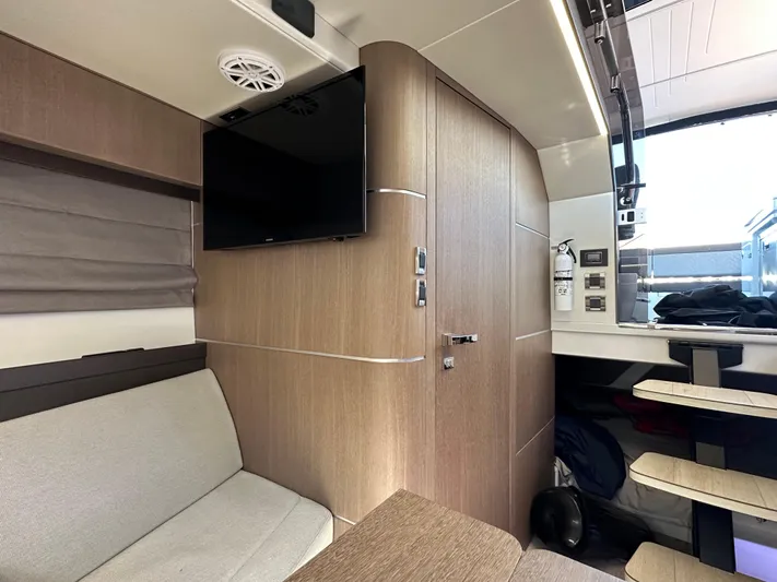  Yacht Photos Pics Interior of 2022 Galeon 325 GTO yacht with modern wood paneling and seating area.