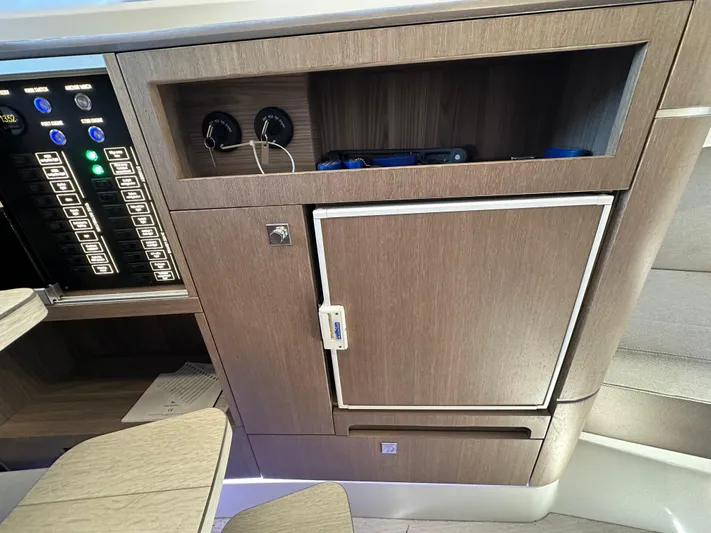  Yacht Photos Pics 2022 Galeon 325 GTO interior with control panel and storage cabinet.