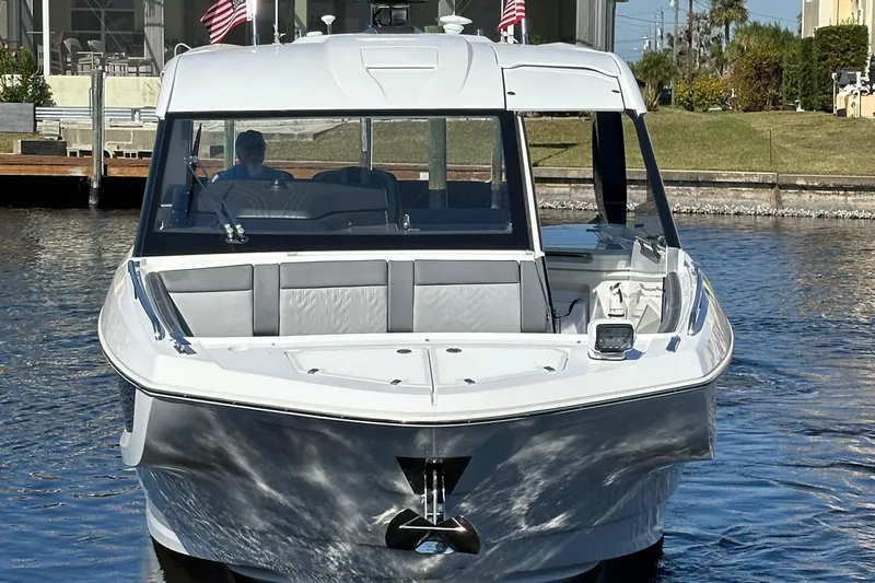  Yacht Photos Pics 2022 Galeon 325 GTO yacht on water, front view with American flags.