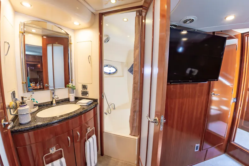 Spring Break Yacht Photos Pics Luxurious 2004 Carver Voyager bathroom with elegant wood finishes and modern amenities.