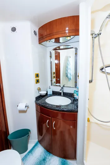 Spring Break Yacht Photos Pics Luxurious 2004 Carver Voyager bathroom with modern fixtures and elegant wood cabinetry.