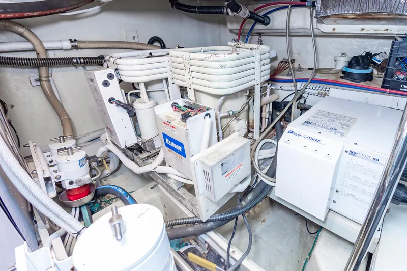 Spring Break Yacht Photos Pics Engine room of a 2004 Carver Voyager with various mechanical components and wiring.