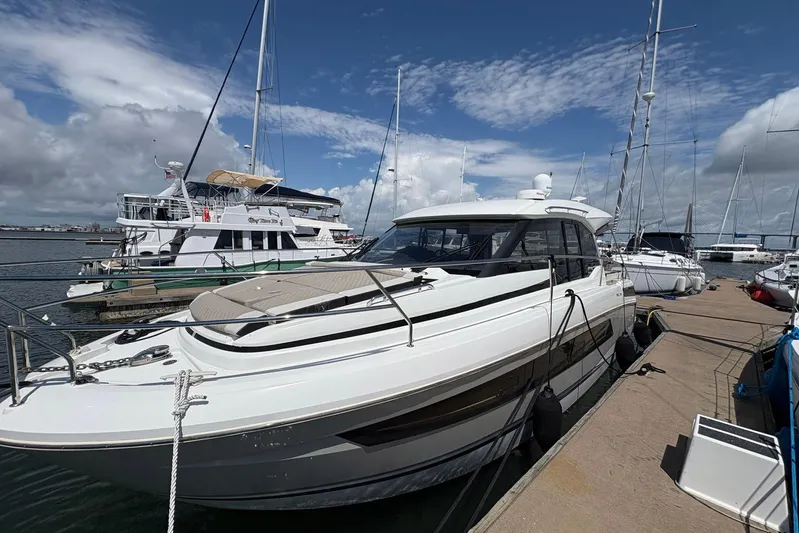  Yacht Photos Pics 2019 Jeanneau NC 33 yacht docked at marina under blue sky.