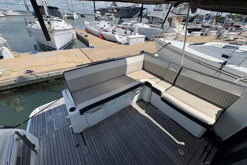  Yacht Photos Pics 2019 Jeanneau NC 33 yacht with spacious deck seating at marina.