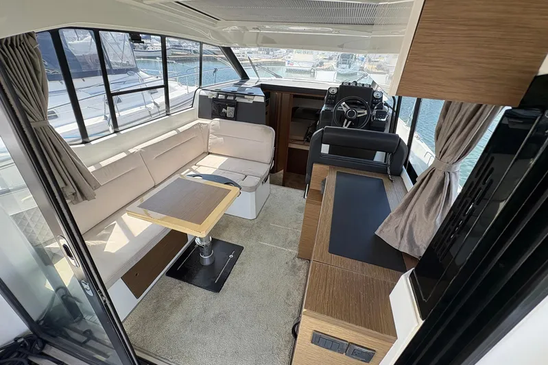  Yacht Photos Pics Interior of 2019 Jeanneau NC 33 yacht with modern seating and helm station.