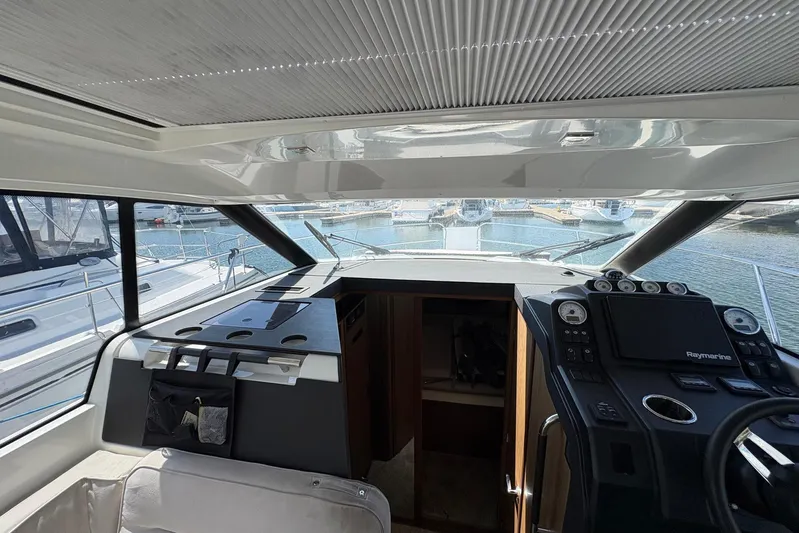  Yacht Photos Pics Interior view of 2019 Jeanneau NC 33 yacht cockpit with navigation equipment.
