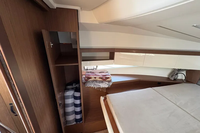  Yacht Photos Pics Interior cabin of 2019 Jeanneau NC 33 boat with bed and storage.