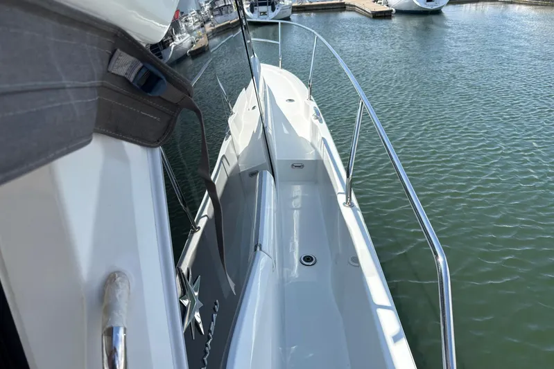  Yacht Photos Pics 2019 Jeanneau NC 33 yacht docked, showcasing sleek deck and railing design.