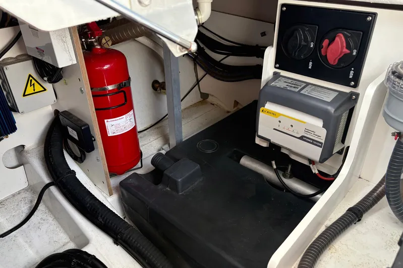  Yacht Photos Pics Engine compartment of 2019 Jeanneau NC 33 with fire extinguisher and electrical components.