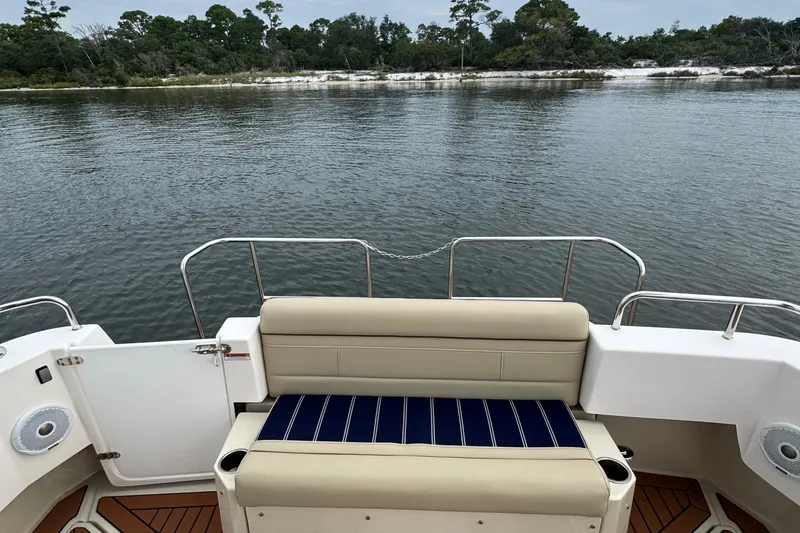  Yacht Photos Pics 2022 Ranger Tugs R-31 CB boat with rear seating, overlooking calm water and shoreline.