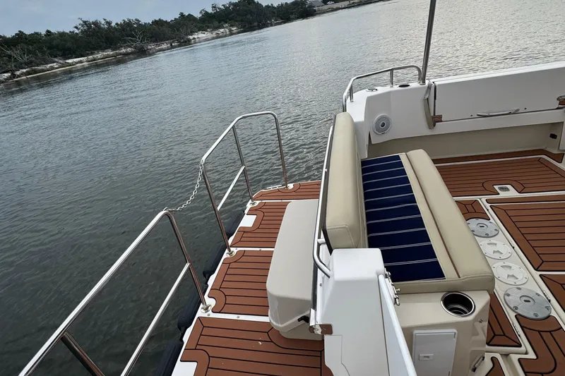  Yacht Photos Pics 2022 Ranger Tugs R-31 CB boat deck with seating, overlooking calm waters.
